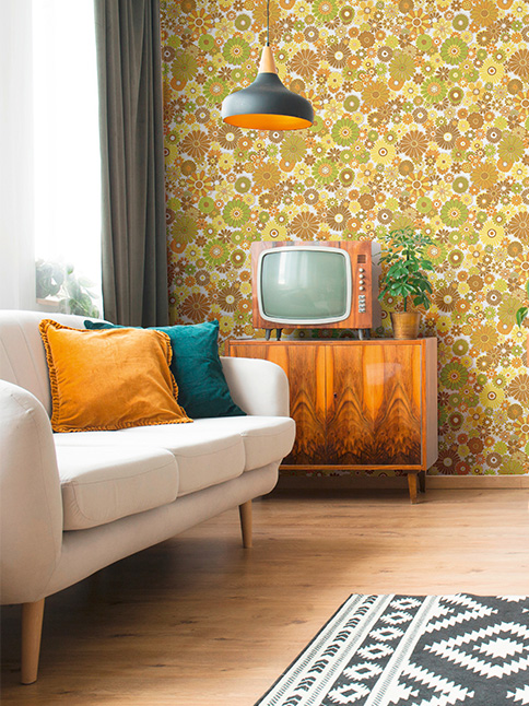 Yellow pattern wallpaper behind a sofa 