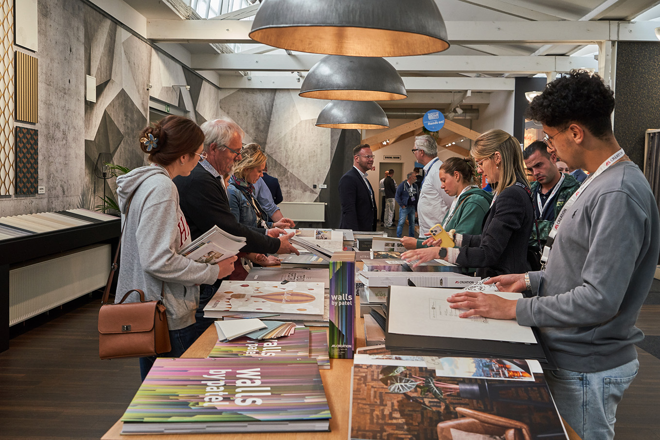 Customers in the showroom looking at wallpaper samples